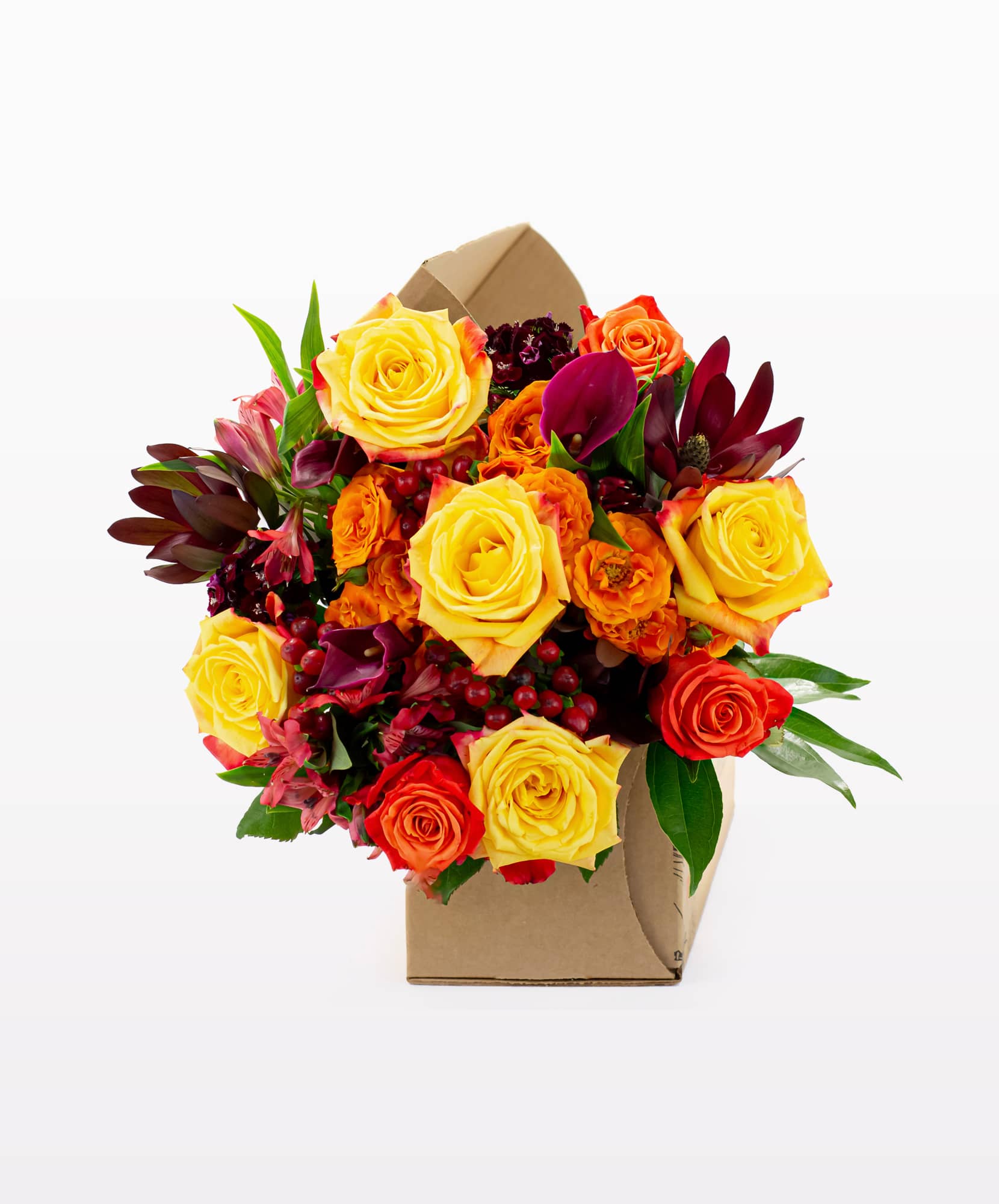 Vibrant bouquet of yellow and orange roses with lush greenery, beautifully arranged.