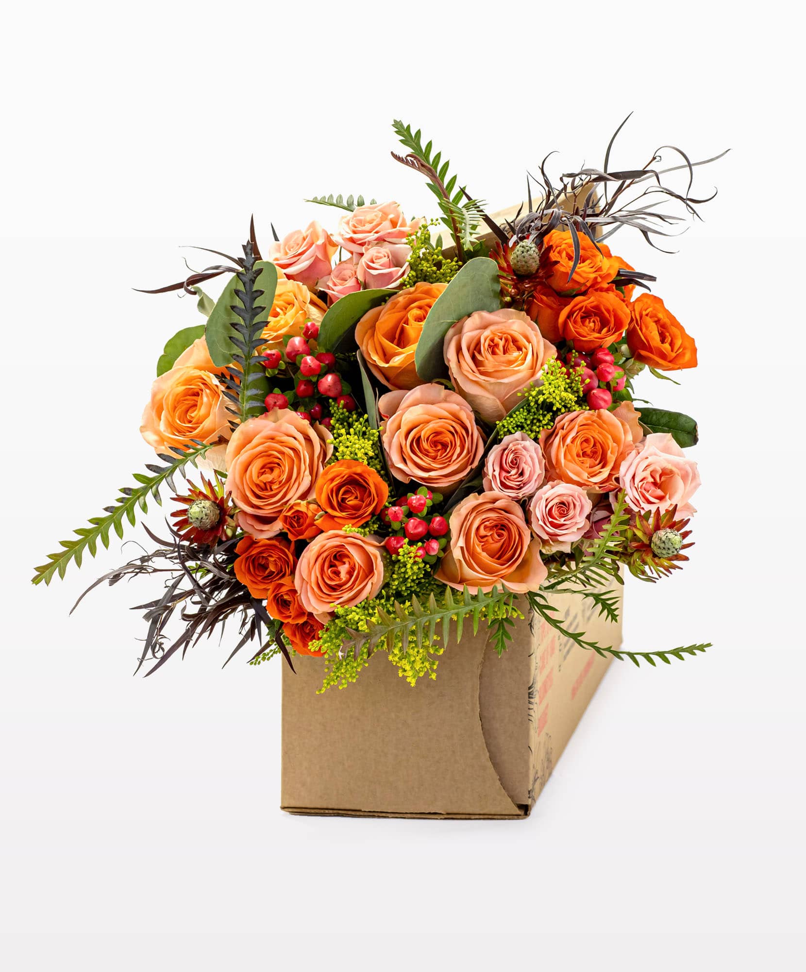 Vibrant orange and pink rose bouquet arranged with greens in an elegant box.