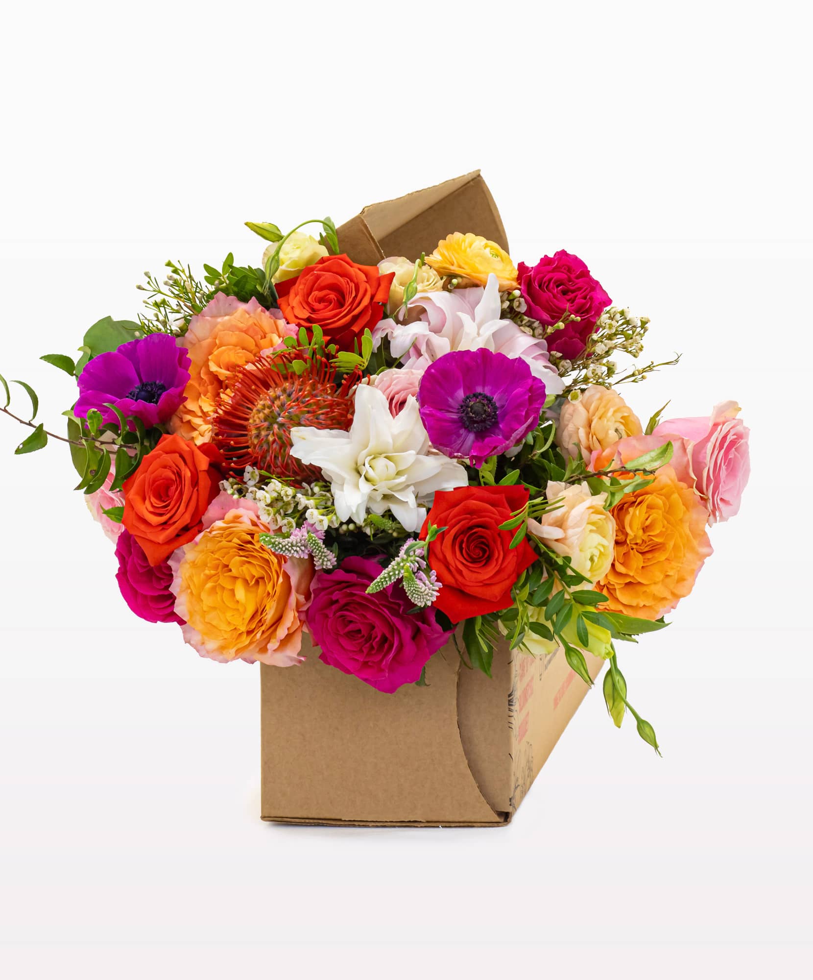 Vibrant floral arrangement with roses, anemones, and greenery in a stylish box.